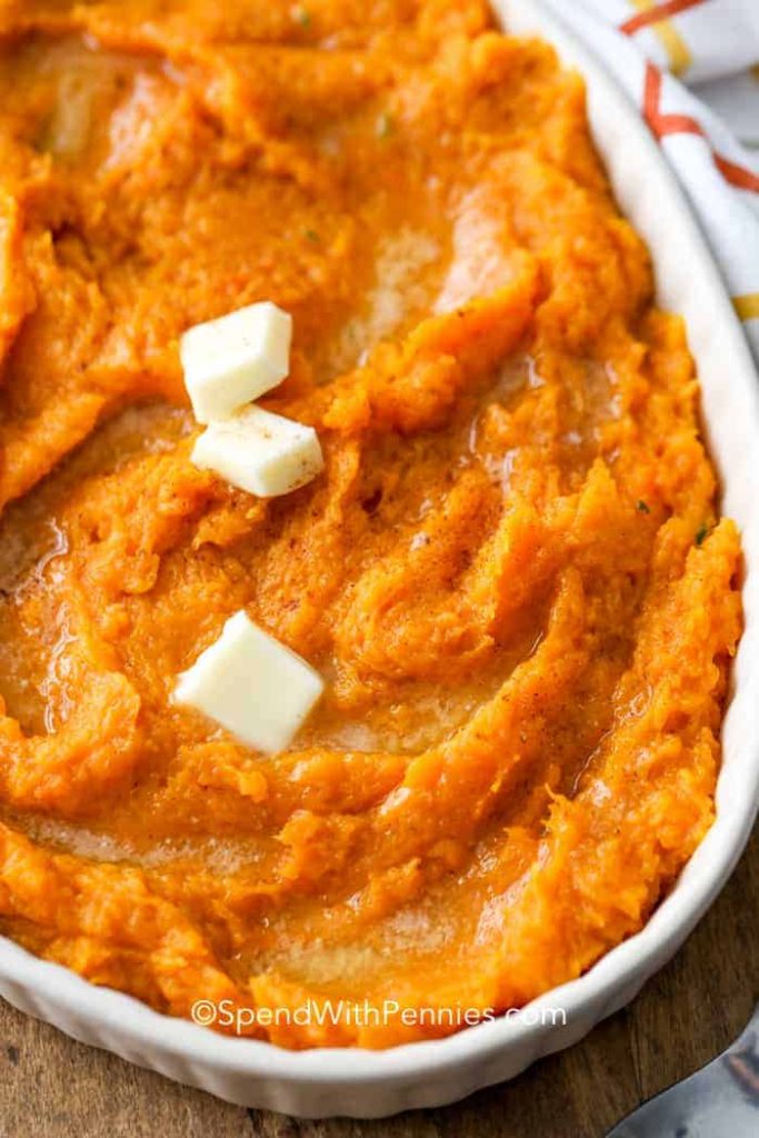 mashed squash in dish with butter and cinnamon