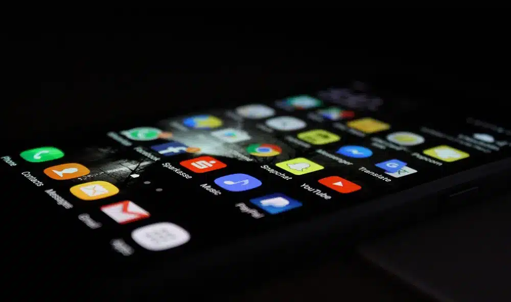 a cell phone with app icons displayed on the screen